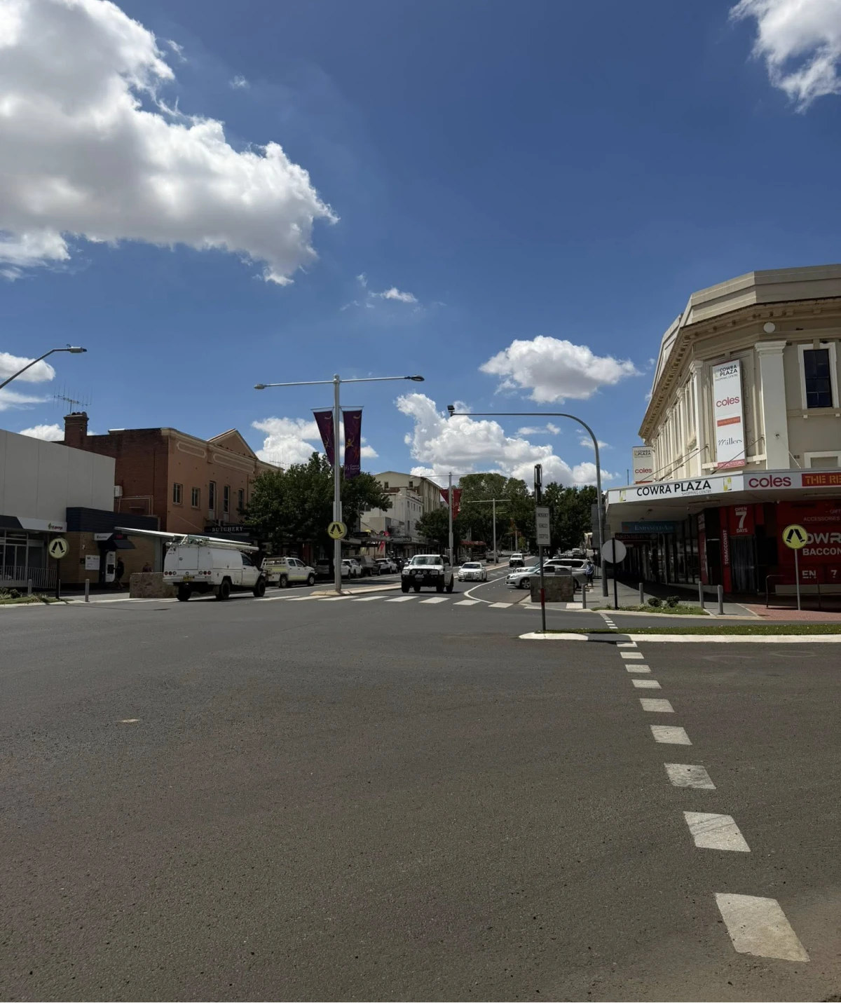 Street intersection under a partly cloudy sky.