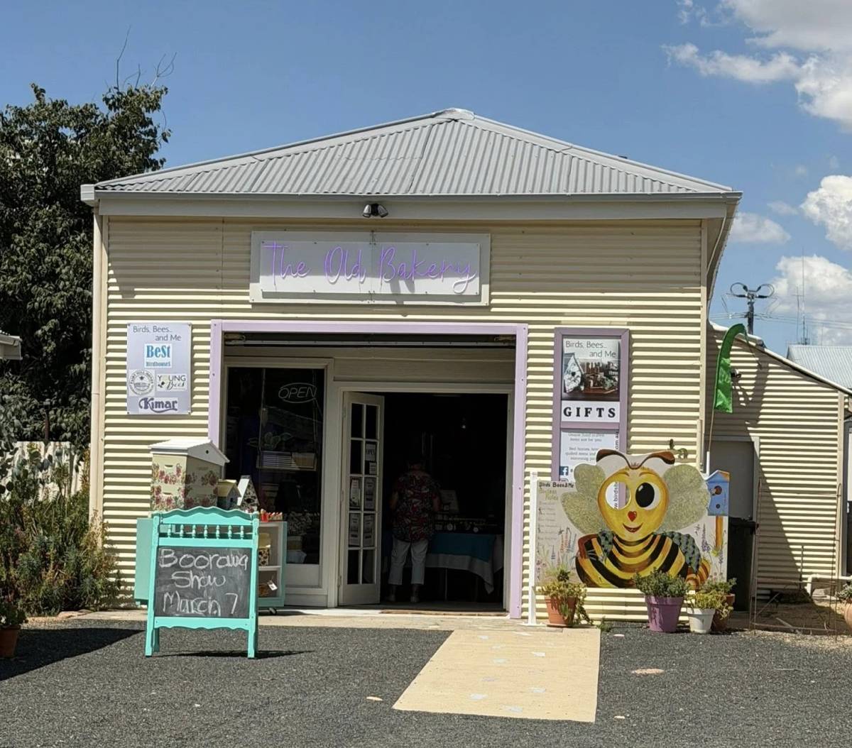 Yellow corrugated iron building with a sign