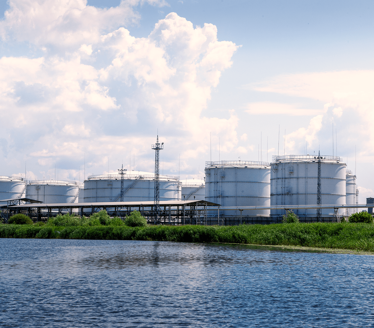 Oil storage tanks by a lake.