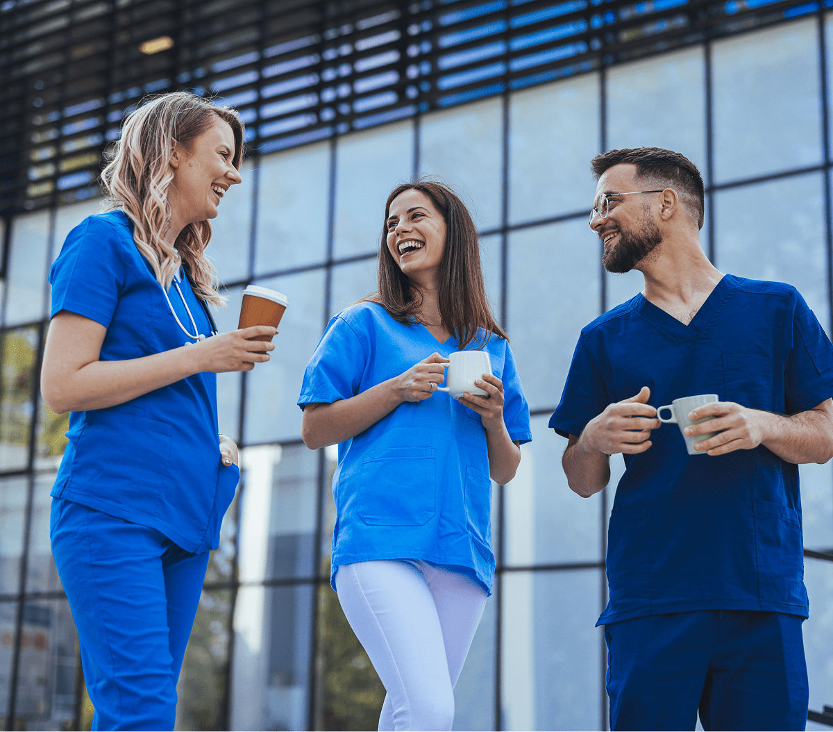 Healthcare workers enjoying a coffee break outside.