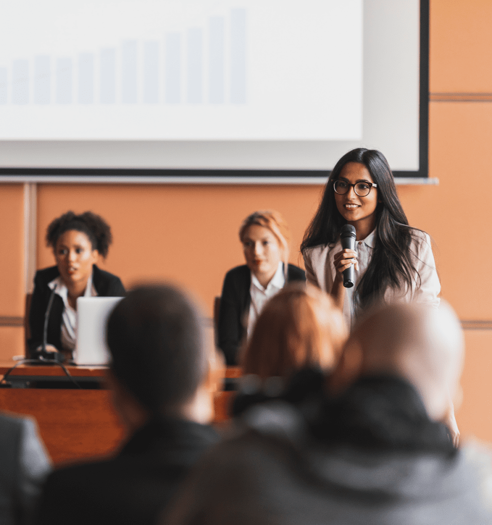 Woman speaking at a business conference.