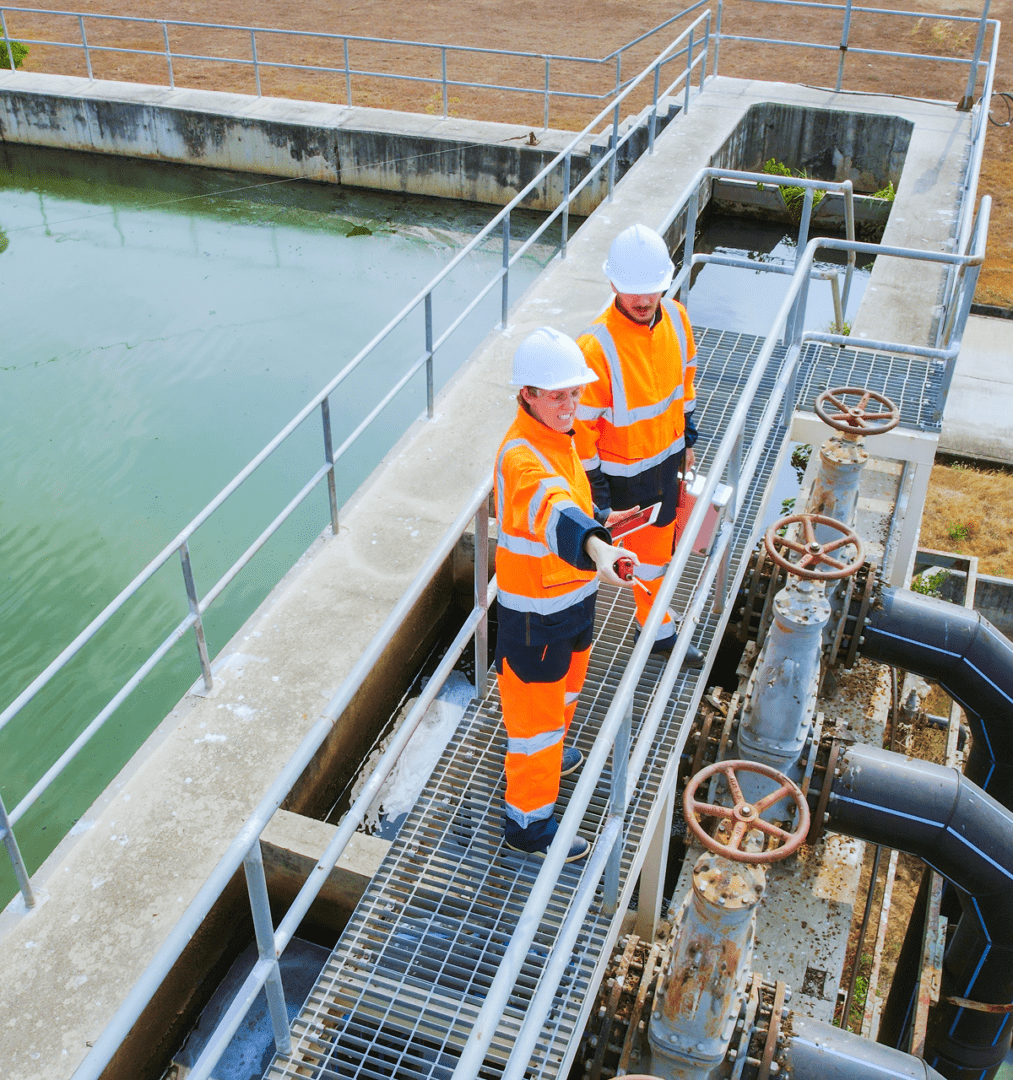 Workers inspecting industrial water treatment facility.