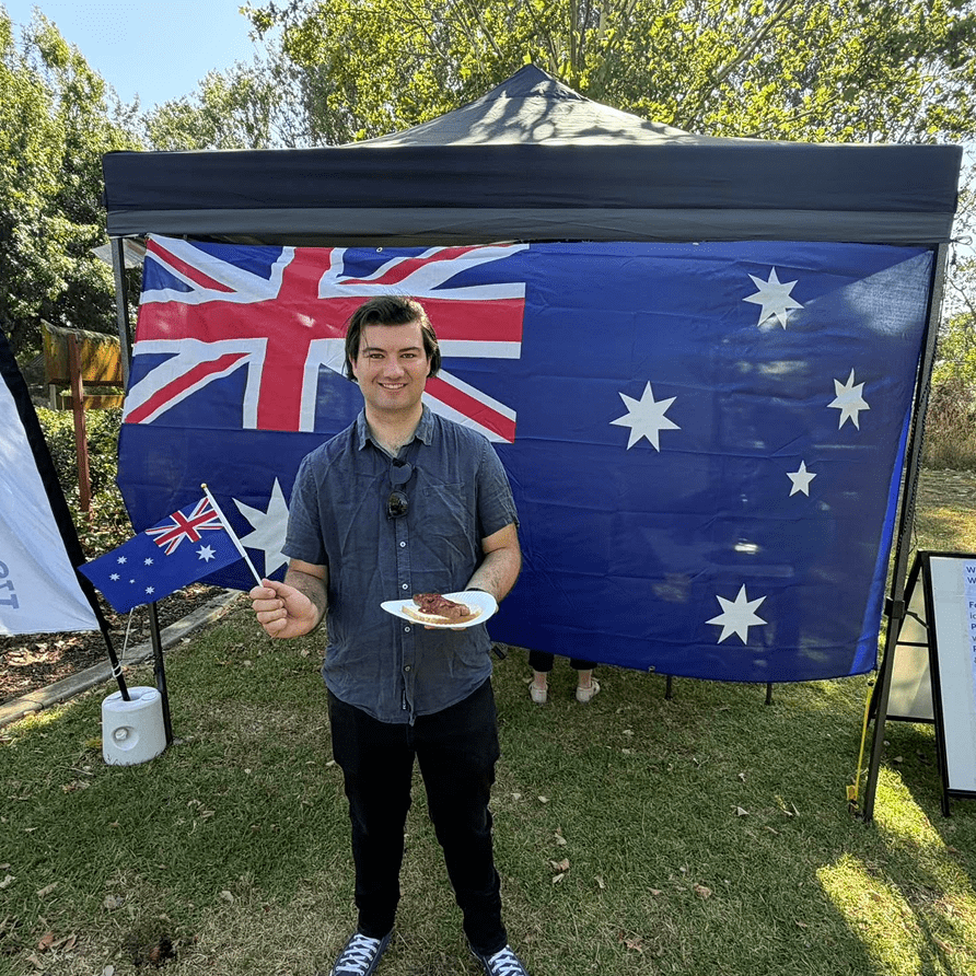 Man holding Australian flag and a plate.